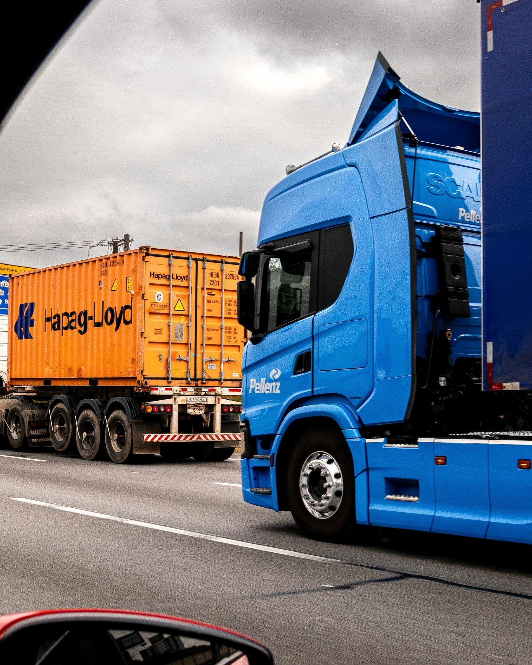 Lorry hauling a shipping container on a motorway