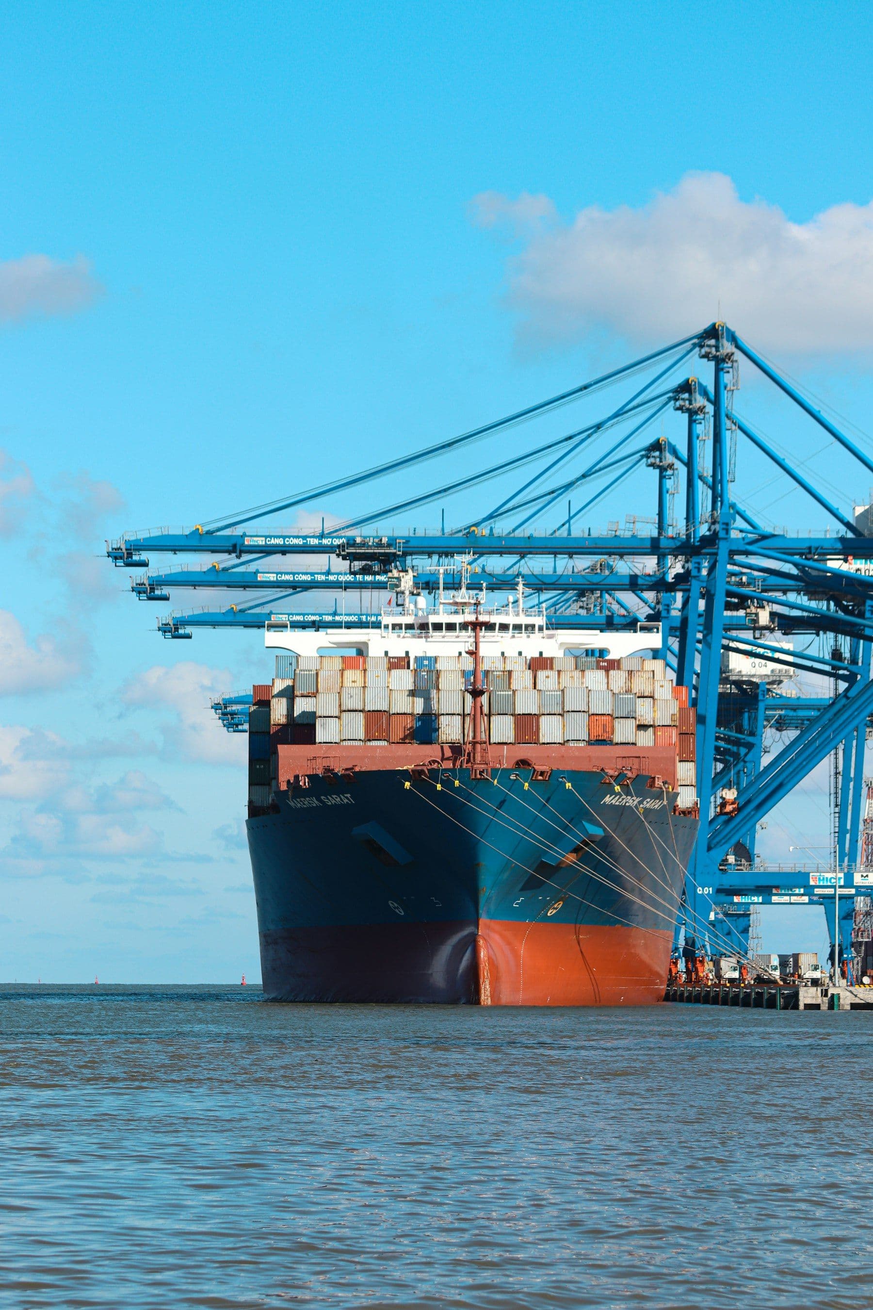 Container ship being loaded by cranes at a port